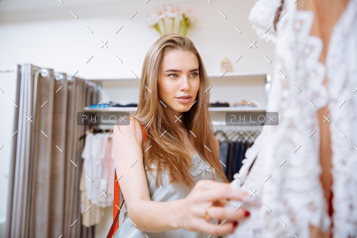 woman-doing-shopping-and-choosing-clothes-in-PDEP6XU